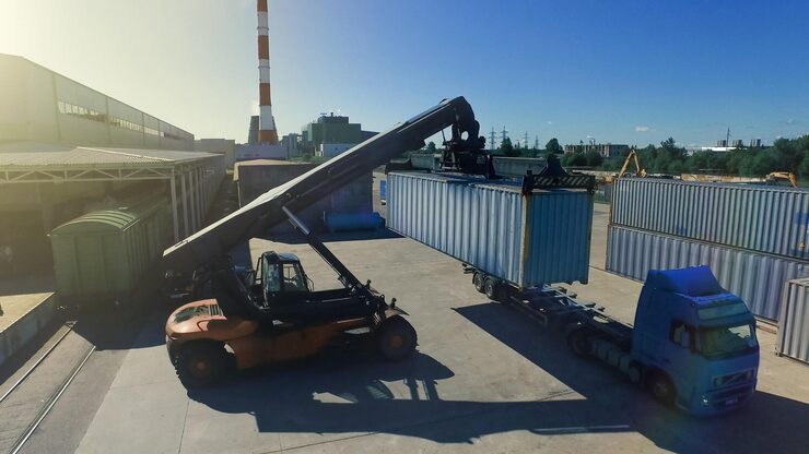forklift-is-loading-container-into-container_861143-1609